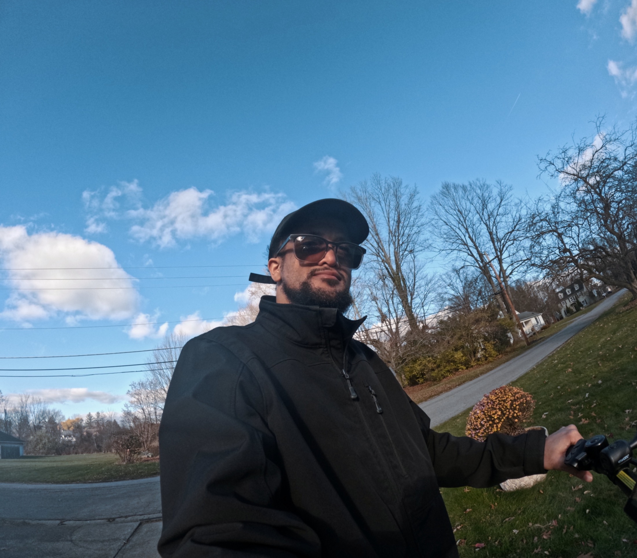 Manuel outdoors beneath a blue sky