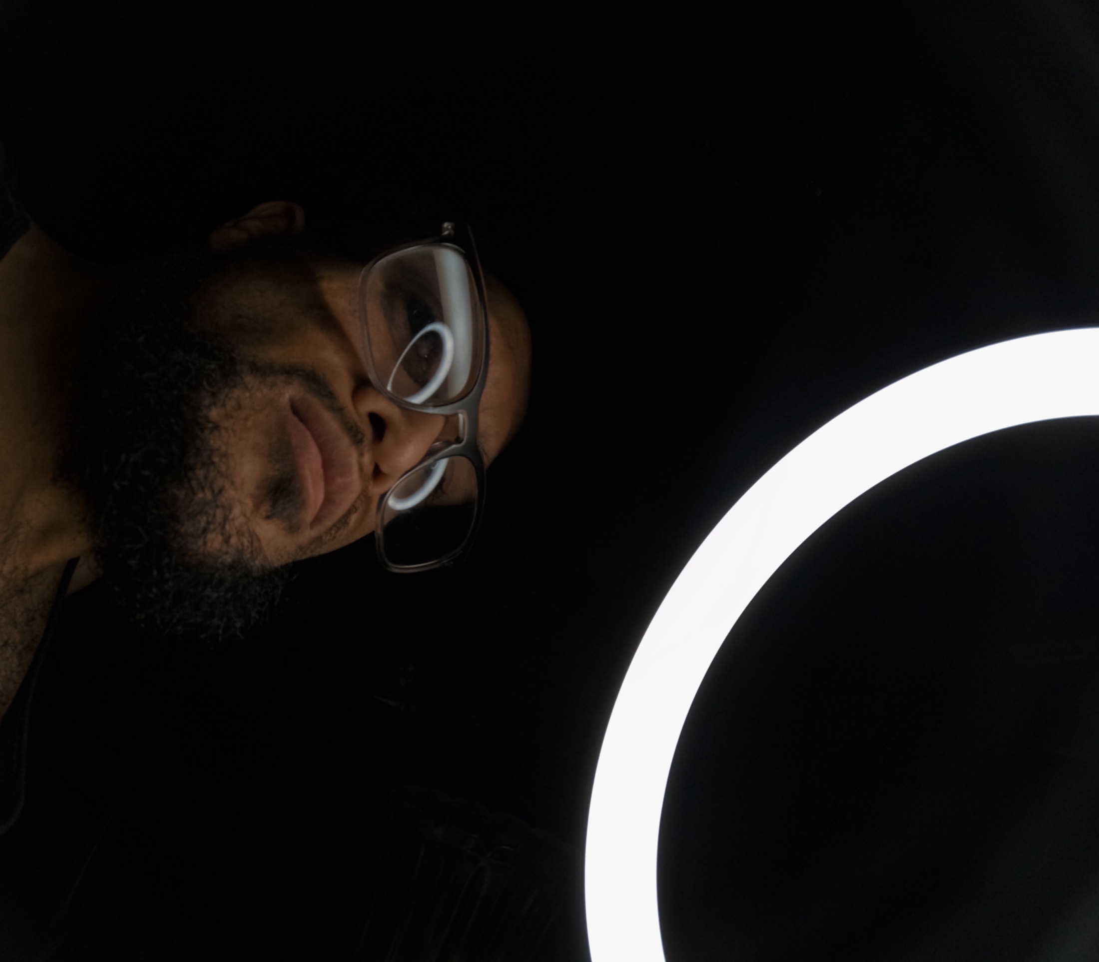 A close studio portrait with a ring light